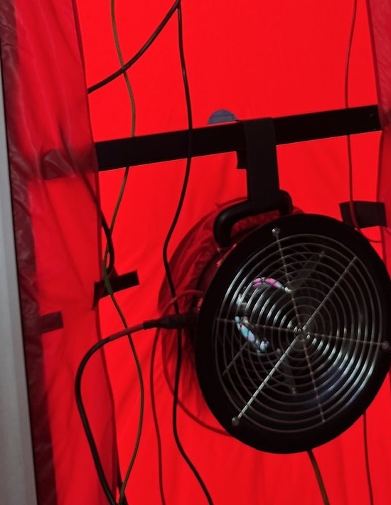 Equipment-only blower-door fan and red shroud installed in a home